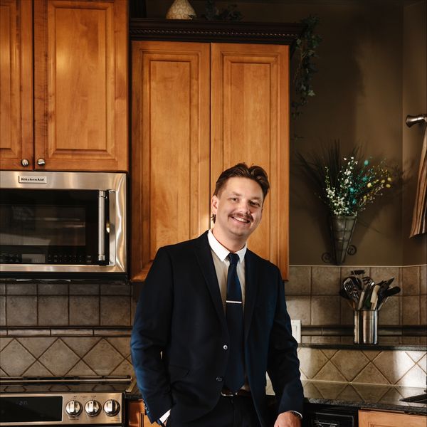 Travis Kuhn, Associate